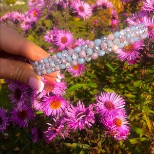 Tiara made of beads and crystals of white, blue and purple colors